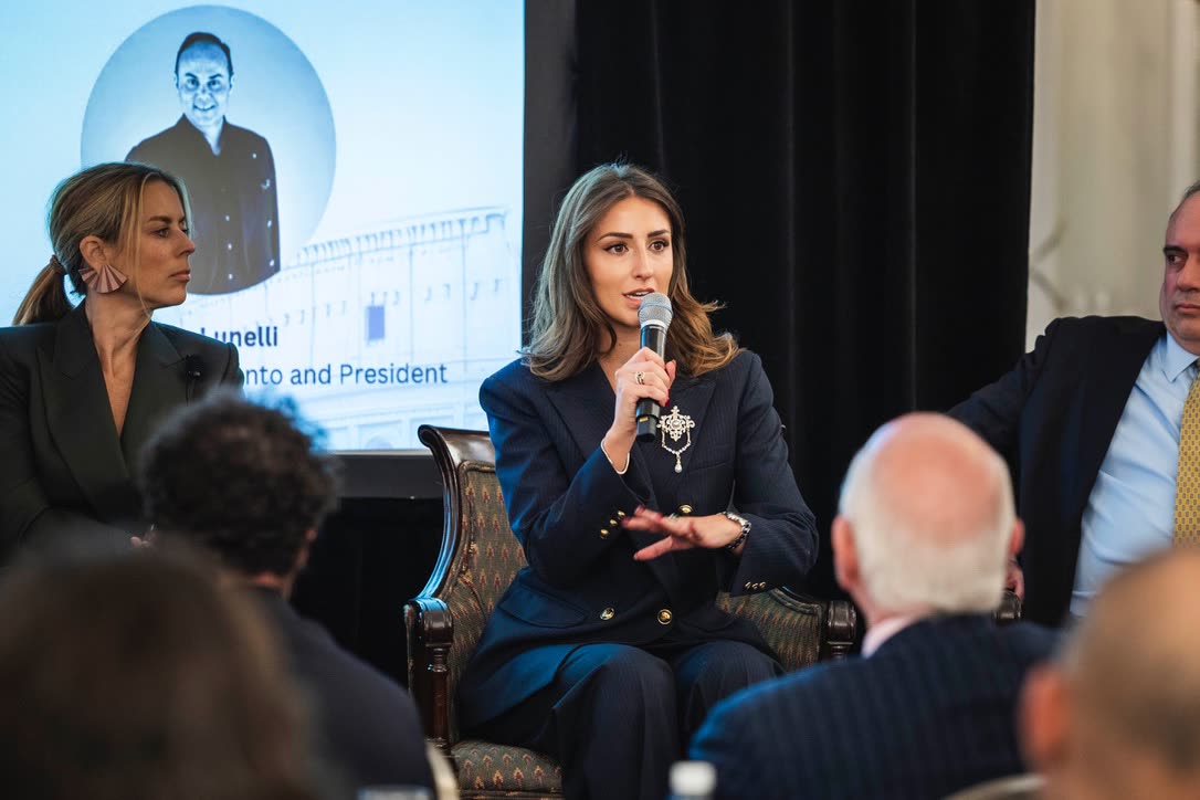 Camilla Brossa answers a question during a panel at the Italian Chamber of Commerce in London, seated among the other speakers in front of the audience